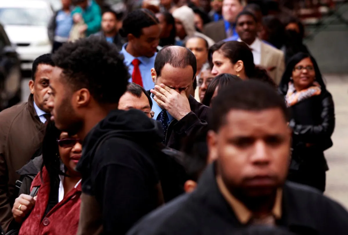 A man rubs his eyes as he waits in a line of job seekers, to attend the Dr. Martin Luther King Jr. career fair held by the New York State department of Labor in New York on April 12, 2012. (Lucas Jackson/Reuters)