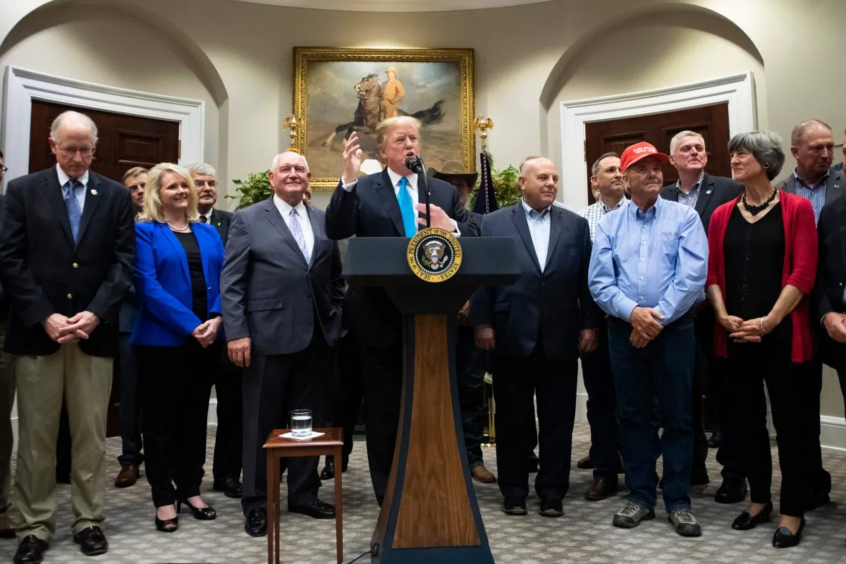 President Donald Trump delivers remarks on supporting America's farmers and ranchers, flanked by Agriculture Secretary Sonny Perdue (C-L), at the White House in Washington, D.C. on May 23, 2019. (Jim Watson/AFP/Getty Images)