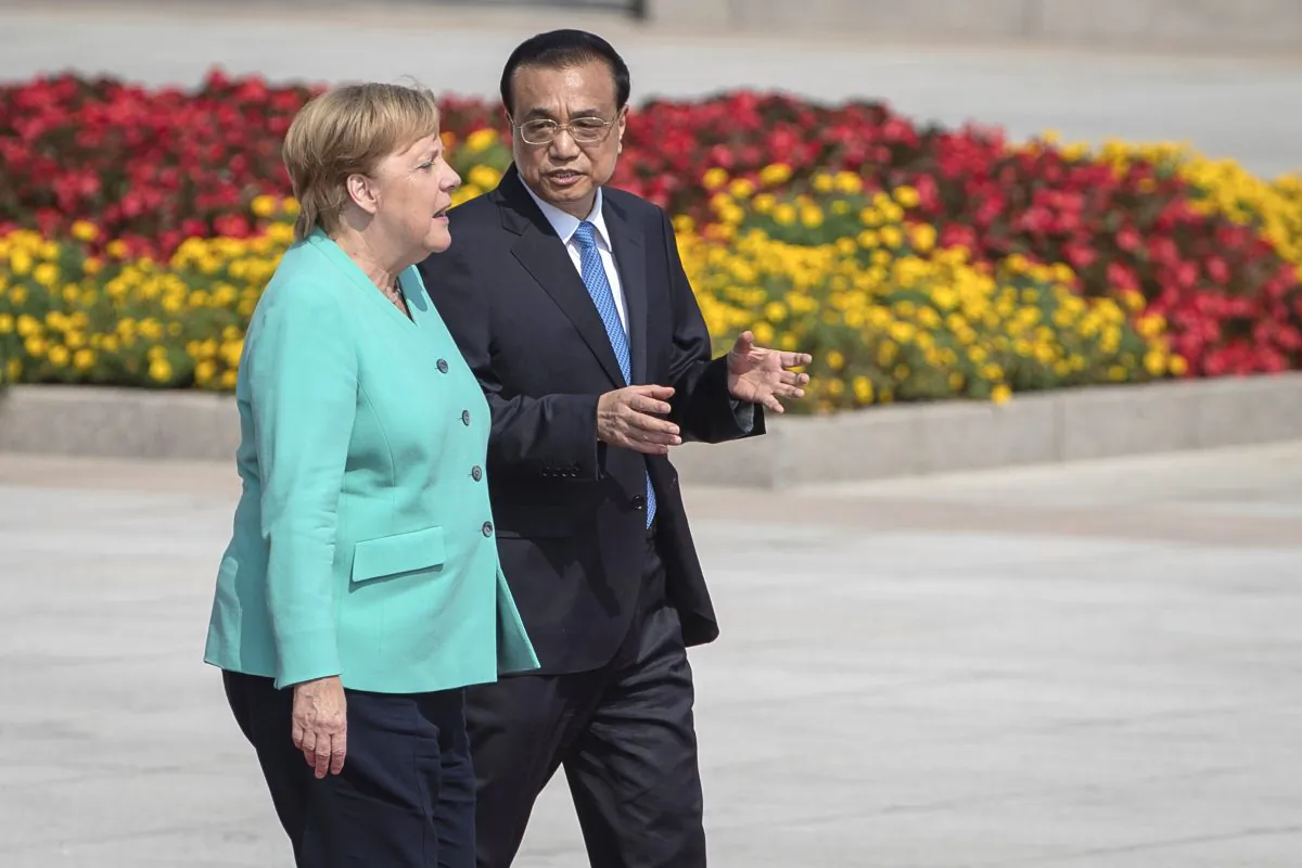 Chinese Premier Li Keqiang, right, and German Chancellor Angela Merkel attend a welcome ceremony at the Great Hall of the People in Beijing, Friday, Sept. 6, 2019. Merkel visits China from Sept. 6-7, 2019. (Roman Pilipey/Pool Photo via AP)