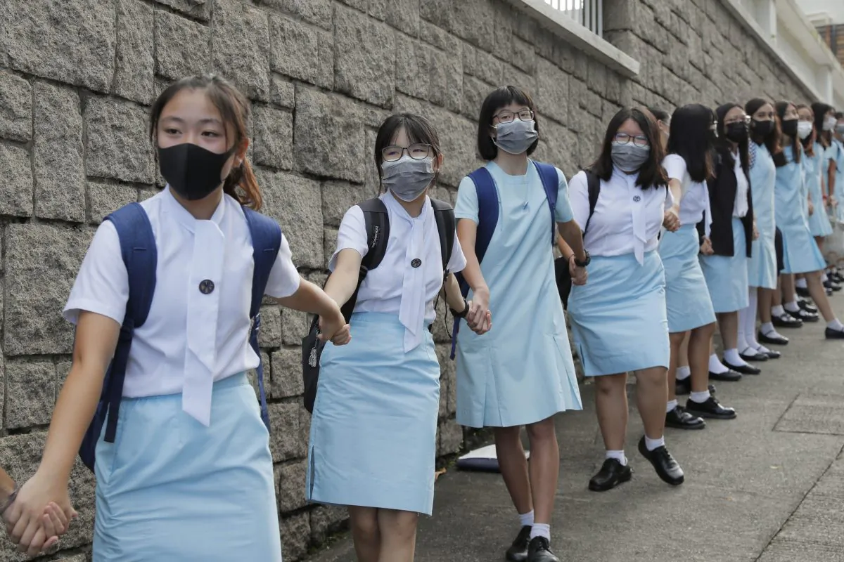 Students form human chain outside the Maryknoll Convent School in Hong Kong, on Sept. 6, 2019, when mass pro-democracy protests were held in the city. (AP Photo/Kin Cheung)
