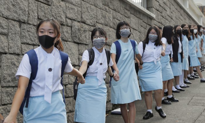 Students form human chain outside the Maryknoll Convent School in Hong Kong, on Sept. 6, 2019, when mass pro-democracy protests were held in the city. (AP Photo/Kin Cheung)
