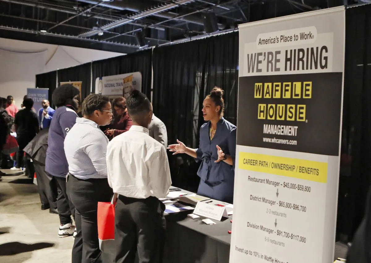 A Waffle House representative speaks to potential applicants during a job and resource fair in Atlanta on Aug. 14, 2019. (Bob Andres/Atlanta Journal-Constitution via AP/)