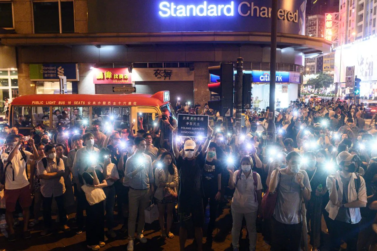 Protesters use the light of their mobile phones as they gather outside the Mong Kok police station in Hong Kong on Sept. 7, 2019. (Philip Fong/AFP/Getty Images)