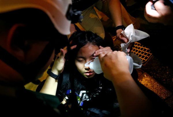 A woman gets first aid near Mong Kok police station in Hong Kong
