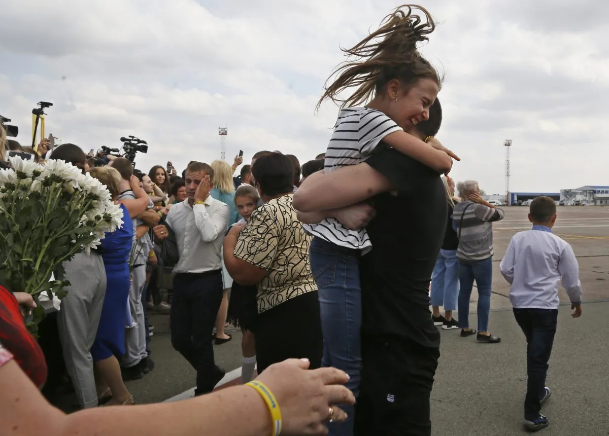 Relatives of Ukrainian prisoners freed by Russia greet them upon their arrival at Boryspil airport, outside Kyiv, Ukraine on Sept. 7, 2019. (AP Photo/Efrem Lukatsky)
