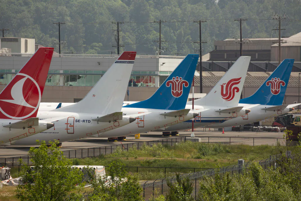 The tails of Boeing 737 MAX airplanes are seen as they sit parked at a Boeing facility adjacent to King County International Airport, known as Boeing Field in Seattle, Washington, on May 31, 2019. (David Ryder/Getty Images)