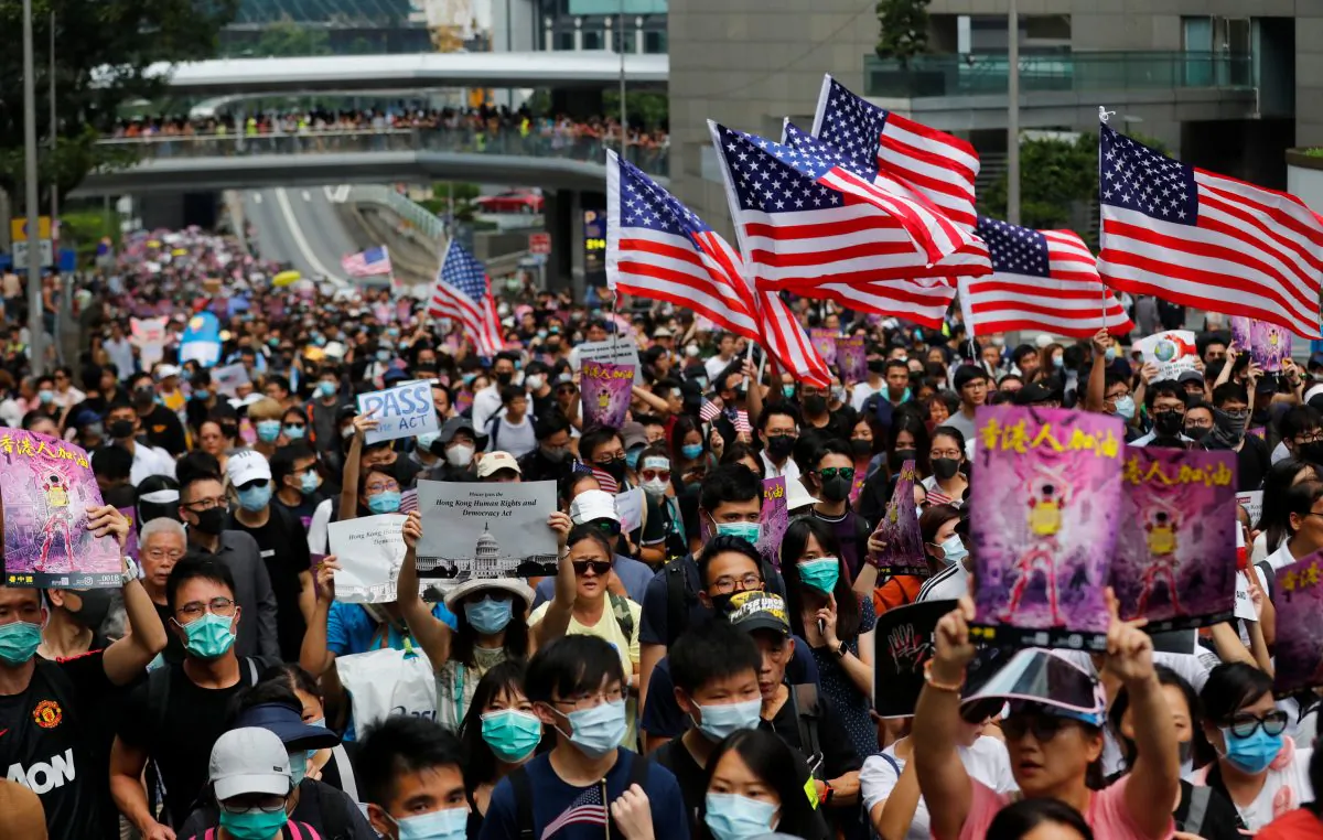 Protesters hold U.S. flags during a march to the U.S. Consulate General in Hong Kong, China, on Sept. 8, 2019. (Anushree Fadnavis/Reuters)
