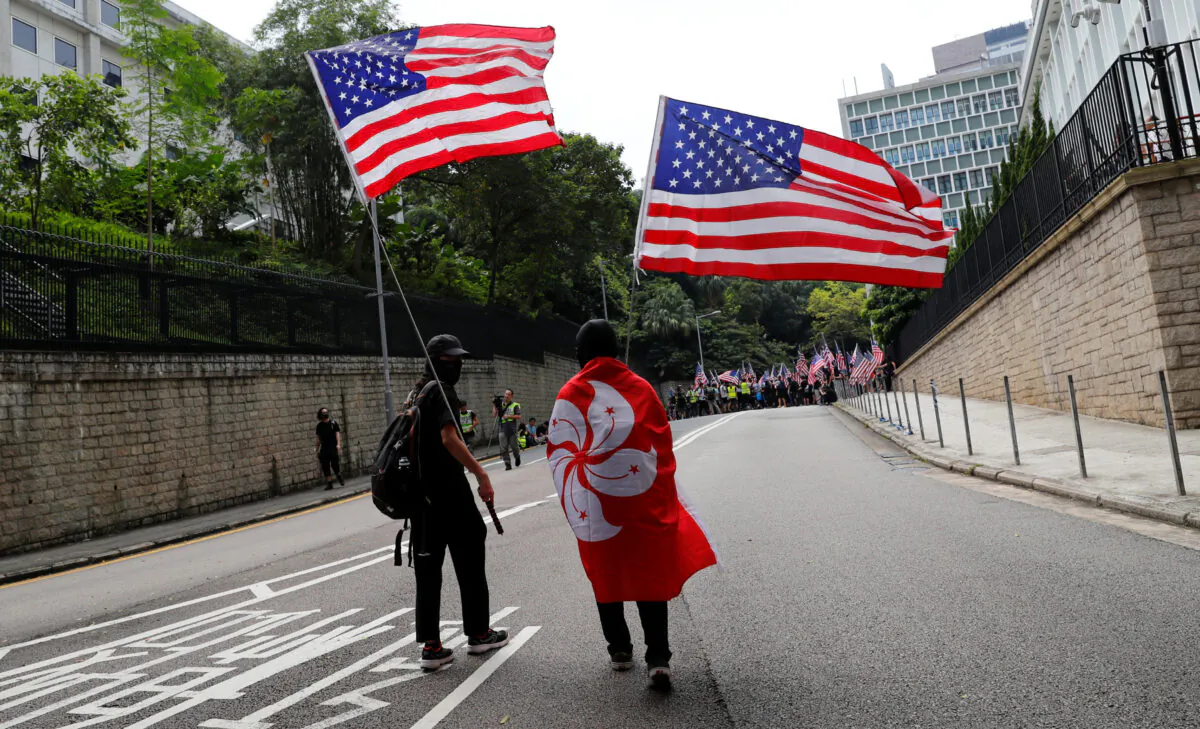 Protesters hold U.S. flags during a march to the U.S. Consulate General in Hong Kong on Sept. 8, 2019. (Anushree Fadnavis/Reuters)