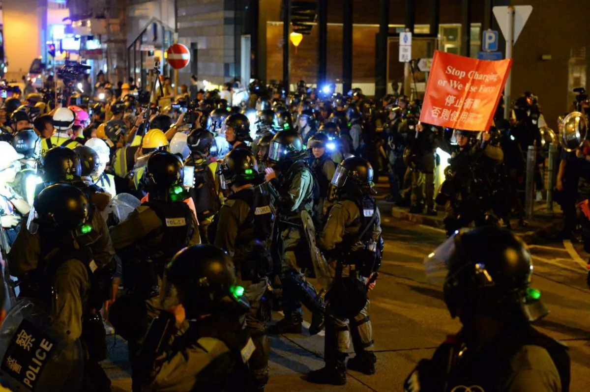 Riot police raise red flags in warning during clashes with protesters in Hong Kong, on Sept. 7, 2019. (Sung Pi Lung/The Epoch Times)