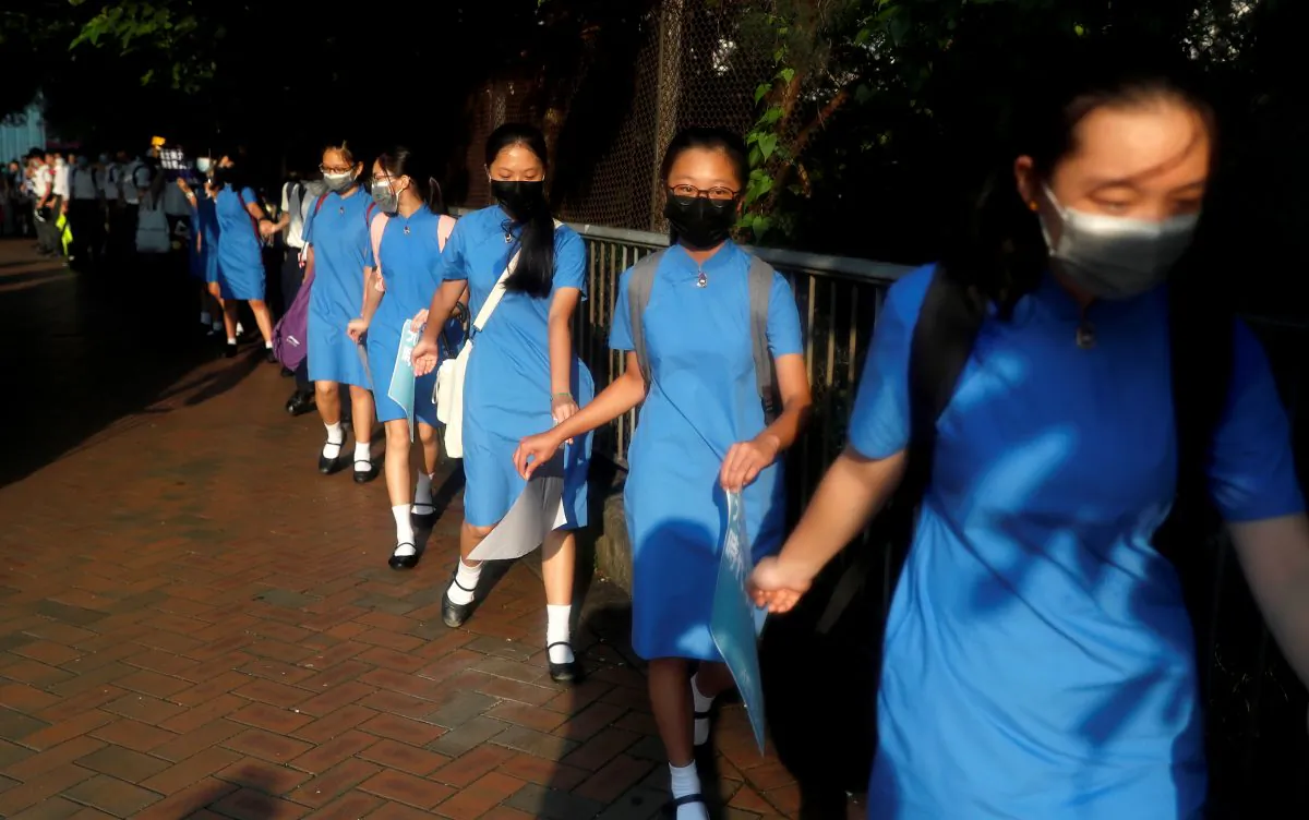 Secondary school students hold hands as they form a human chain as they demonstrate against what they say is police brutality against protesters, after clashes at Wan Chai district, in Hong Kong, China on Sept. 9, 2019. (Amr Abdallah Dalsh/Reuters)