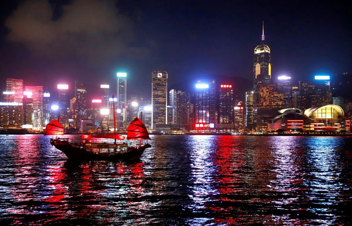 A junk boat passes the skyline as seen from the Tsim Sha Tsui waterfront in Hong Kong, China on Aug. 27, 2019. (Kai Pfaffenbach/Reuters)