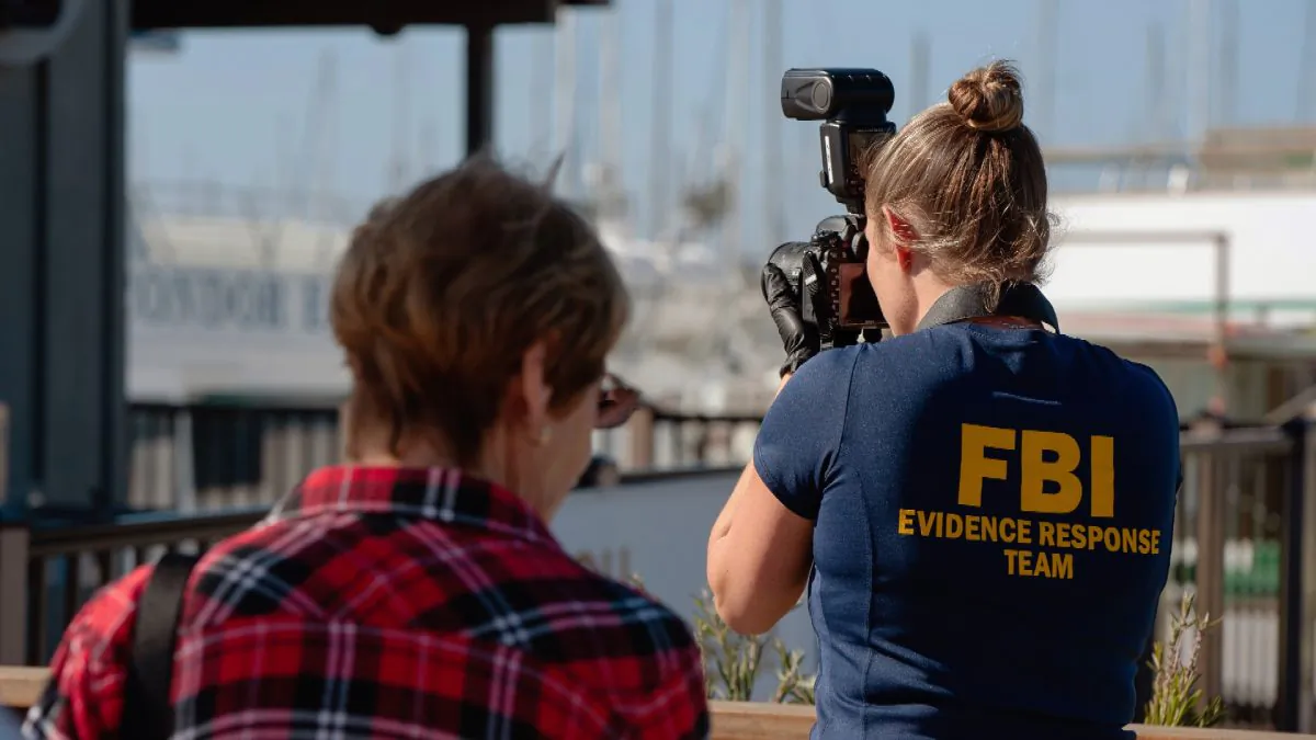 An FBI photographer takes evidence pictures as authorities search the Truth Aquatics' offices, the California company that owned the scuba diving boat that caught fire and killed dozens of people last week, on the Santa Barbara Harbor in Santa Barbara, Calif., on Sept. 8, 2019. (Christian Monterrosa/AP Photo)