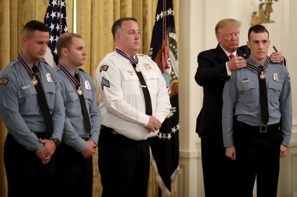 President Donald Trump presents the Medal of Valor to Officer David Denlinger of the Dayton Police Department during a White House ceremony in Washington on Sept. 9, 2019. (Win McNamee/Getty Images)