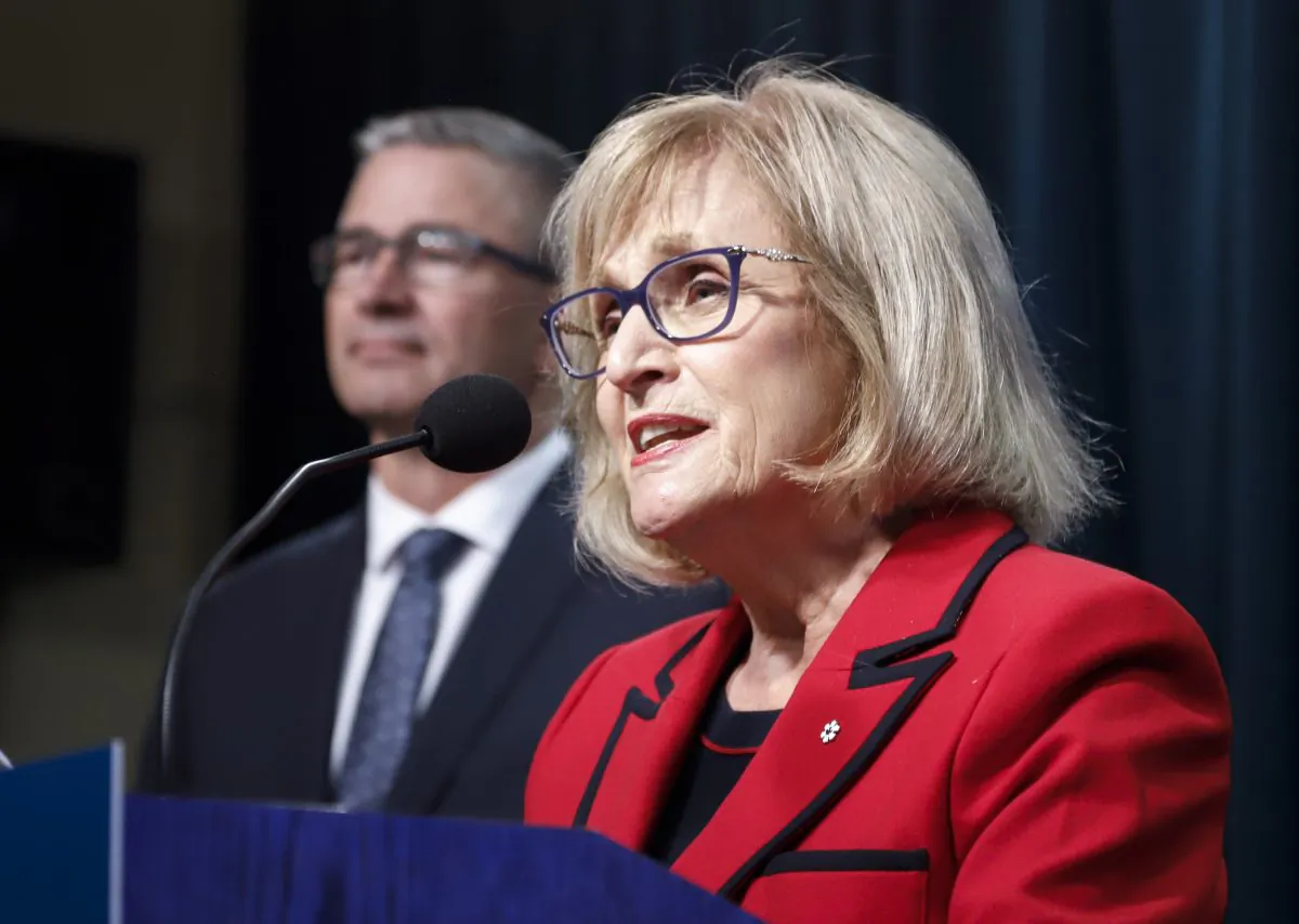 Janice MacKinnon, chair of the Blue Ribbon Panel on Alberta’s Finances, and Travis Toews, Alberta’s minister of finance, speak to the media about the panel's report on Sept. 3, 2019. (The Canadian Press/Jeff McIntosh)
