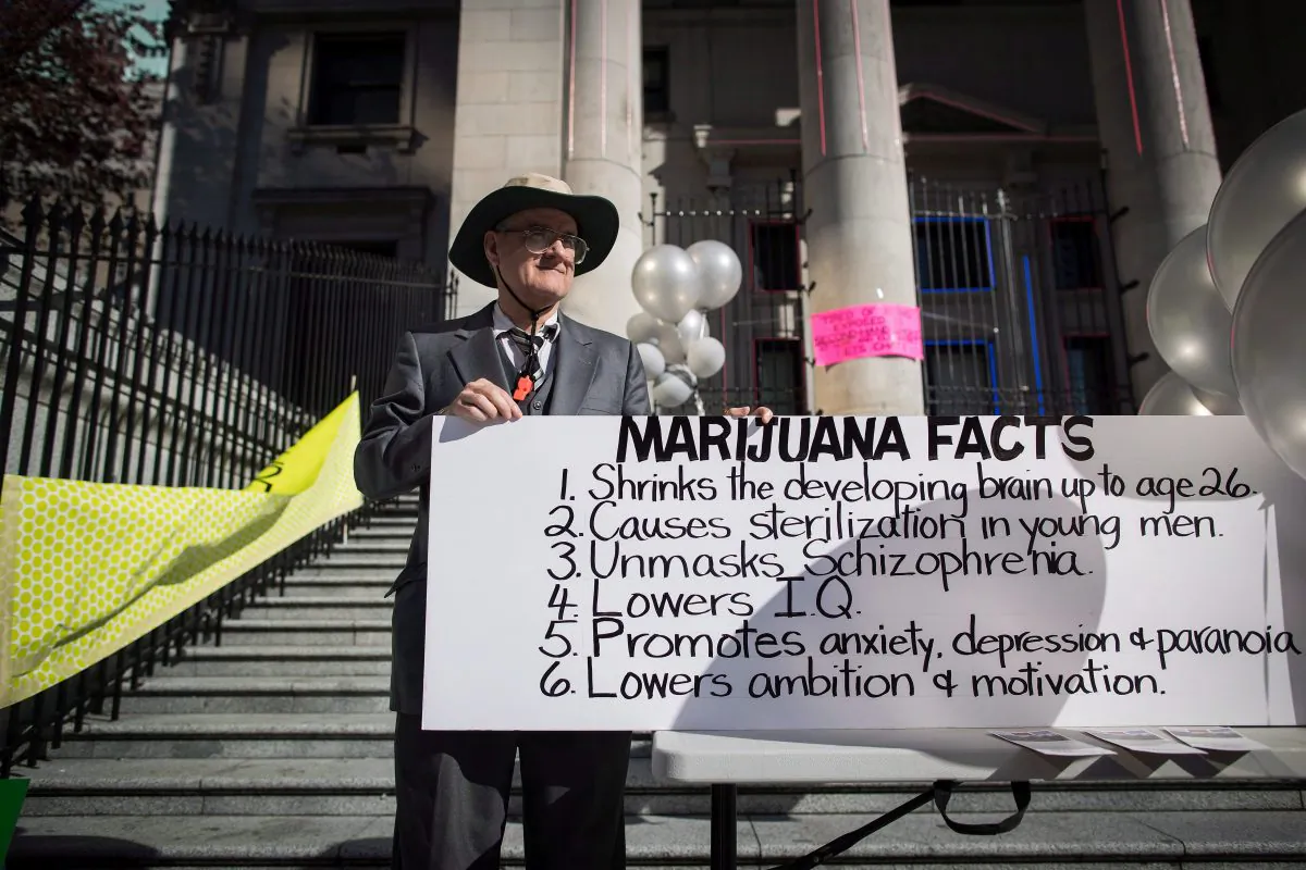 A man holds a sign during a protest about the dangers of marijuana in Vancouver on the day recreational cannabis became legal, Oct. 17, 2018. (THE CANADIAN PRESS/Darryl Dyck)