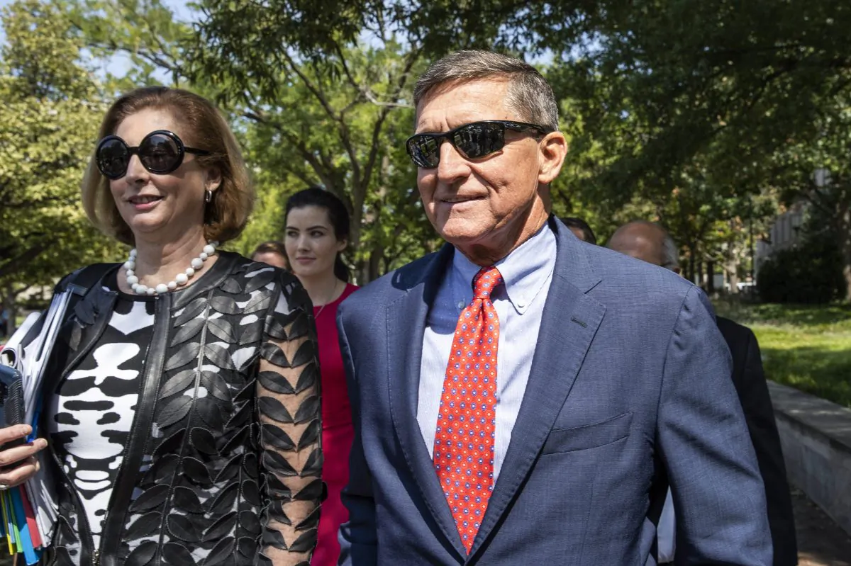 Michael Flynn, President Donald Trump's former national security adviser, leaves the federal court with his lawyer Sidney Powell following a status conference with Judge Emmet Sullivan in Washington on Sept. 10, 2019. (Manuel Balce Ceneta/AP Photo)
