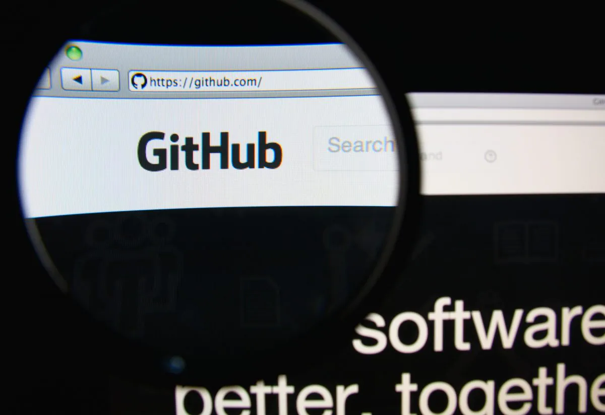 The GitHub homepage through a magnifying glass, in Lisbon, Portugal, on Feb. 19, 2014. GitHub is a web-based hosting service for software developers. (Shutterstock.com/Gil C)