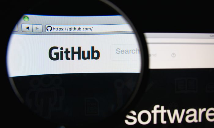 The GitHub homepage through a magnifying glass, in Lisbon, Portugal, on Feb. 19, 2014. GitHub is a web-based hosting service for software developers. (Shutterstock.com/Gil C)
