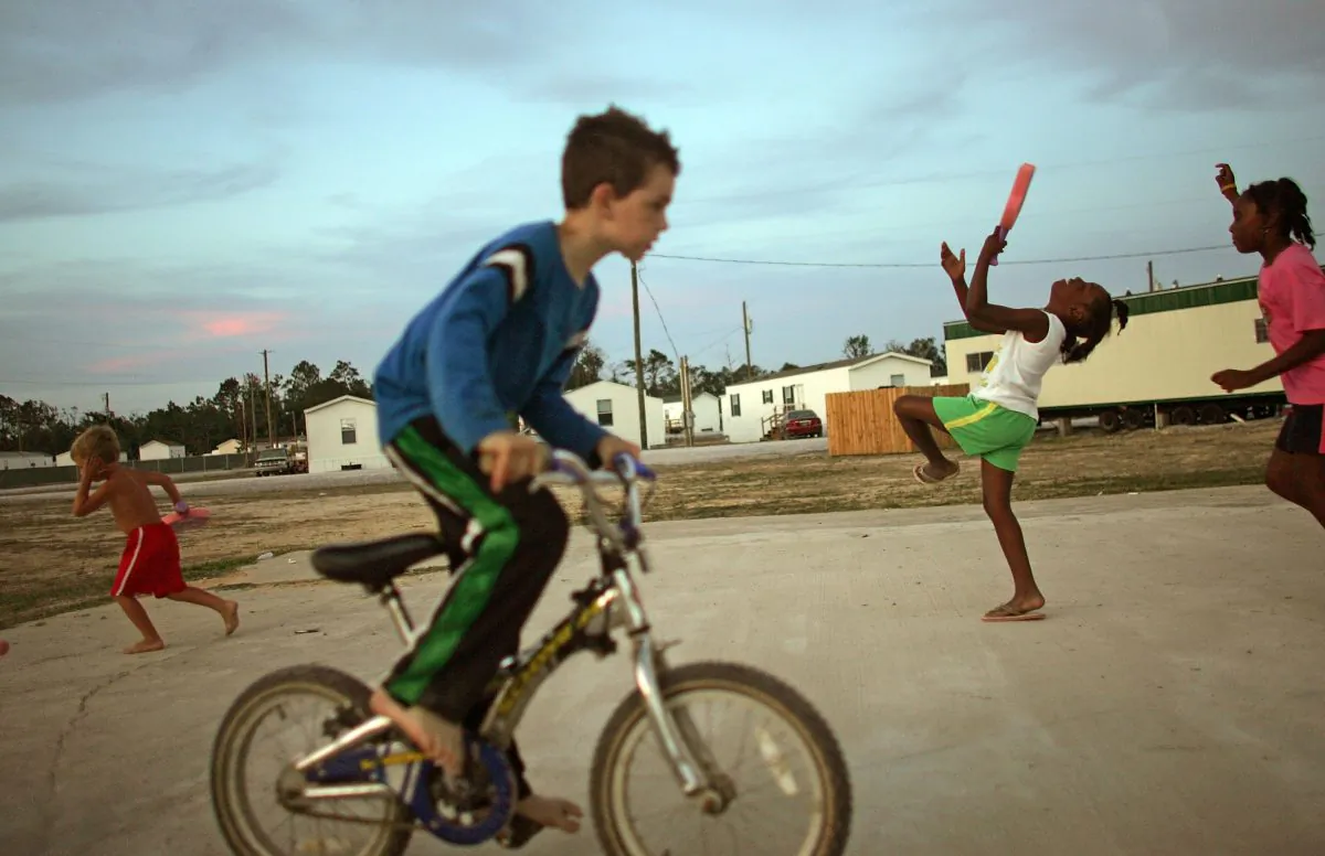 WAVELAND, MS - MAY 27: Children play in the FEMA trailer park where they live after their homes were destroyed by Hurricane Katrina May 27, 2006 in Waveland, Mississippi. The Gulf Coast has been slow to recover from the storm and the next hurricane season begins June 1st. (Photo by Mario Tama/Getty Images)