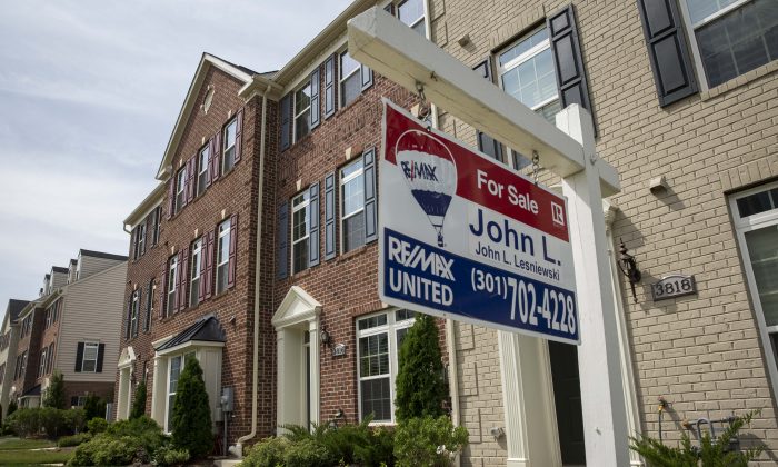 A for sale" sign sits in the front yard of a townhouse Jun. 23, 2015 in Northeast Washington, DC. (Drew Angerer/Getty Images)