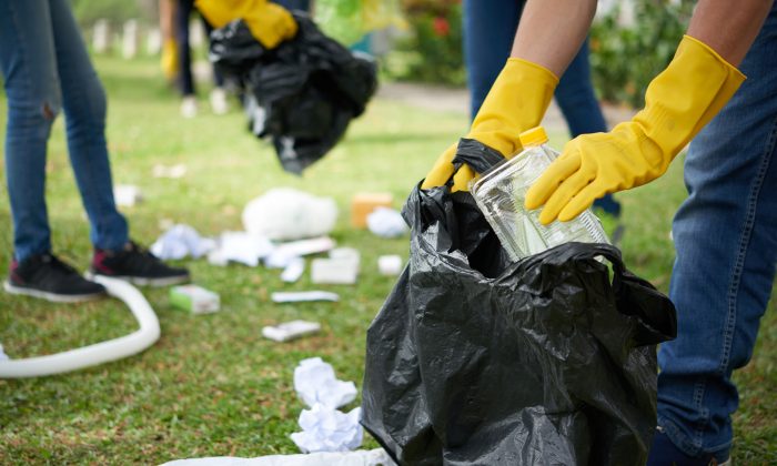 People pick up trash in a stock photo. (Illustration - Shutterstock)