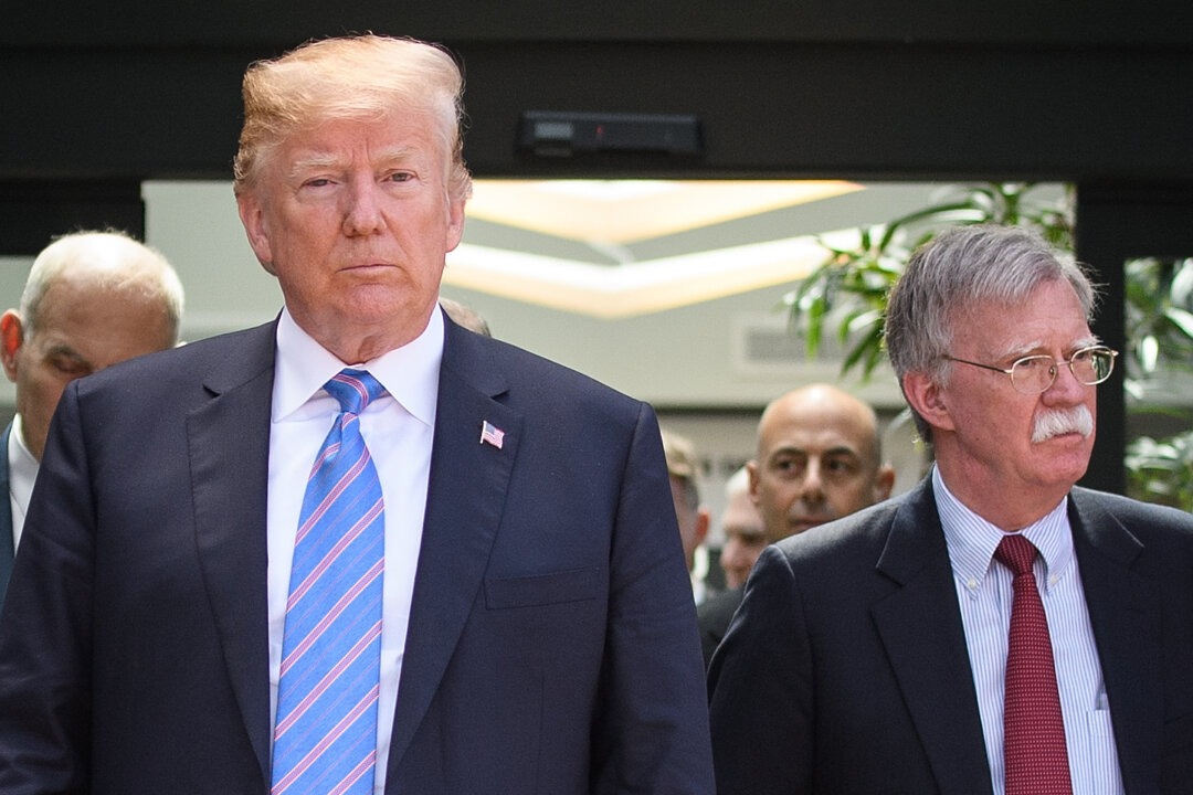 President Donald Trump (C) leaves with National Security Adviser John Bolton (R) after holding a press conference ahead of his early departure from the G-7 Summit in La Malbaie, Canada, on June 9, 2018. (Leon Neal/Getty Images)