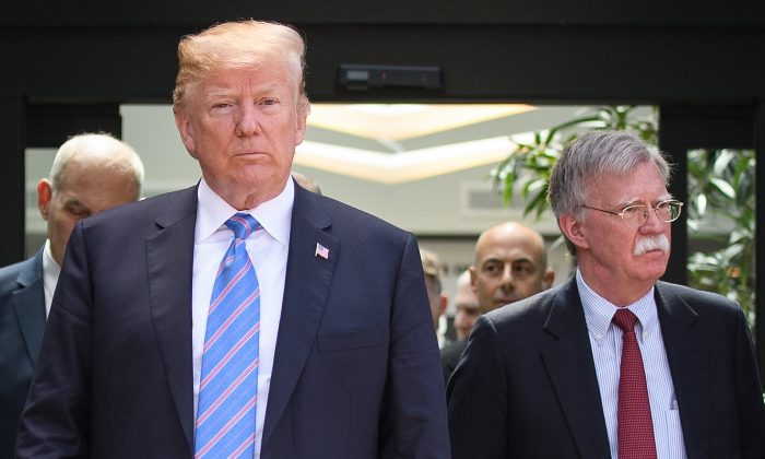 President Donald Trump (C) leaves with National Security Adviser John Bolton (R) after holding a press conference ahead of his early departure from the G-7 Summit in La Malbaie, Canada, on June 9, 2018. (Leon Neal/Getty Images)