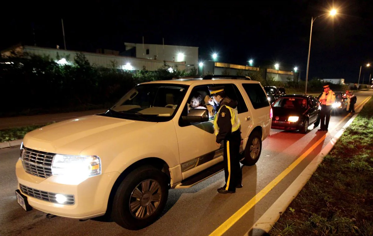 RCMP officers look for impaired drivers during a roadside check in Surrey, B.C., in a file photo. (The Canadian Press/Darryl Dyck)