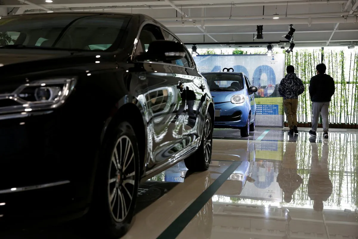 Men visit an electric automobile dealership in Shanghai, China on Jan. 11, 2017. (Aly Song/Reuters)