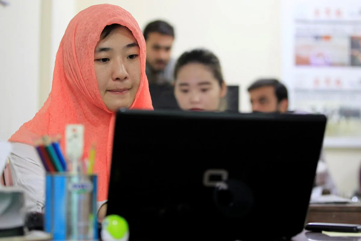 Reporters work at the office of Hushang, a Mandarin language weekly newspaper, in Islamabad, Pakistan on June 9, 2017. (Caren Firouz/Reuters)