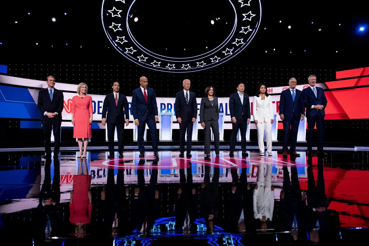 Democratic presidential hopefuls (L-R) US Senator from Colorado Michael Bennet, US Senator from New York Kirsten Gillibrand, former US Secretary of Housing and Urban Development Julian Castro, US Senator from New Jersey Cory Booker, former Vice President Joe Biden, US Senator from California Kamala Harris, US entrepreneur Andrew Yang, US Representative for Hawaii's 2nd congressional district Tulsi Gabbard, Governor of Washington Jay Inslee and Mayor of New York City Bill de Blasio arrive on stage ahead of the second round of the second Democratic primary debate of the 2020 presidential campaign season hosted by CNN at the Fox Theatre in Detroit, Michigan on July 31, 2019. BRENDAN SMIALOWSKI/AFP/Getty Images