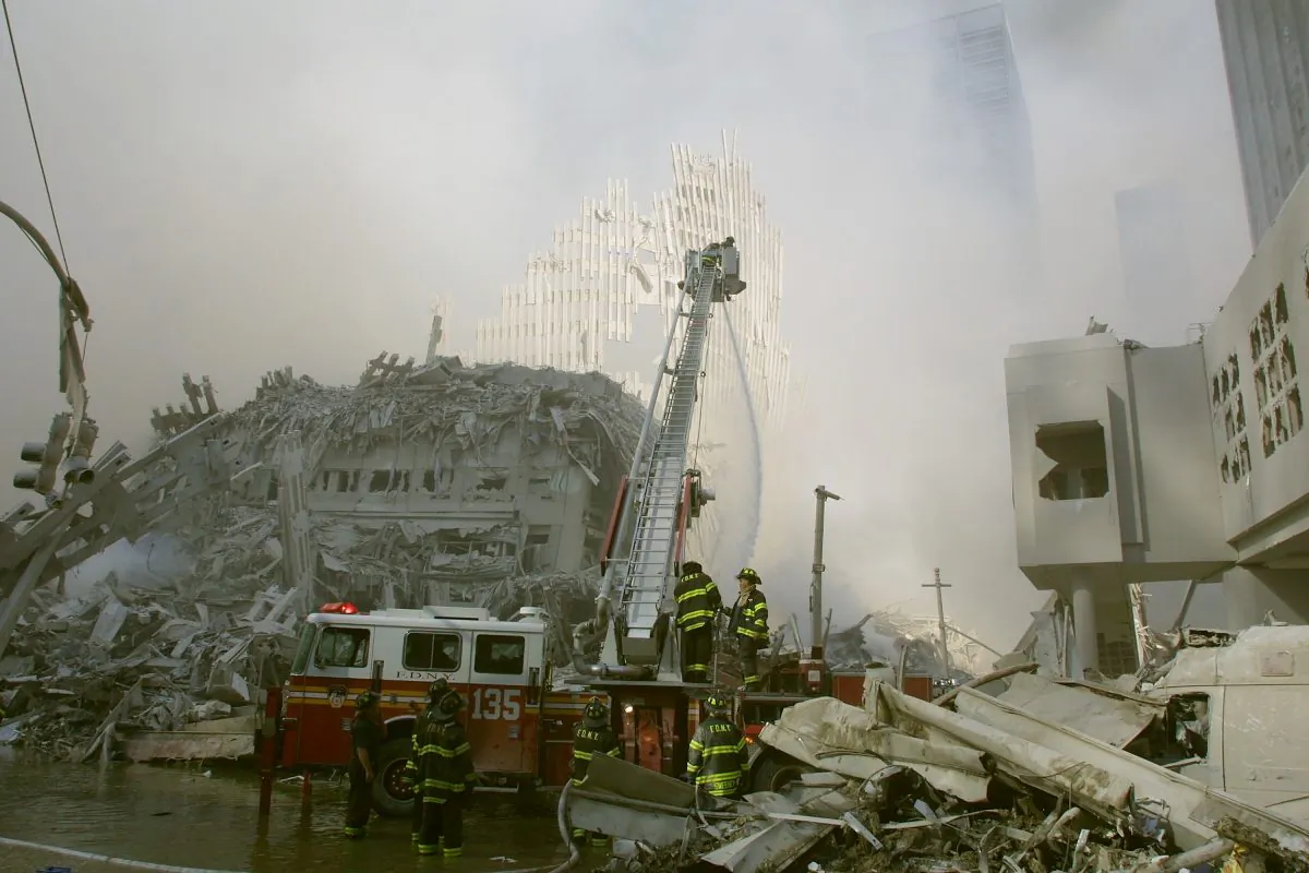 New York City firefighters work at the World Trade Center after two hijacked planes crashed into the Twin Towers in New York on Sept. 11, 2001. (Ron Agam/Getty Images)