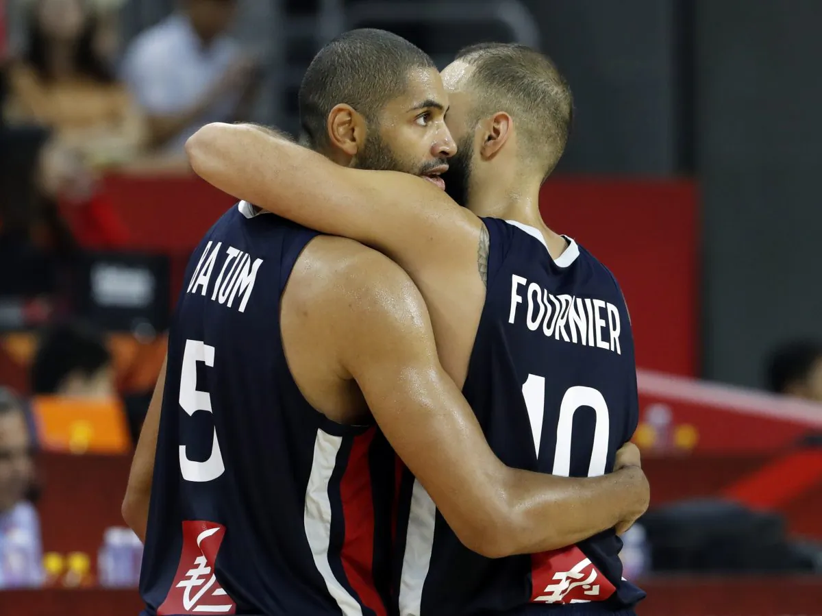 Basketball - FIBA World Cup - Quarter Finals - United States v France - Dongguan Basketball Center, Dongguan, China - Sept. 11, 2019. France's Nicolas Batum and Evan Fournier celebrate victory after the match. (Kim Kyung-Hoon/Reuters)