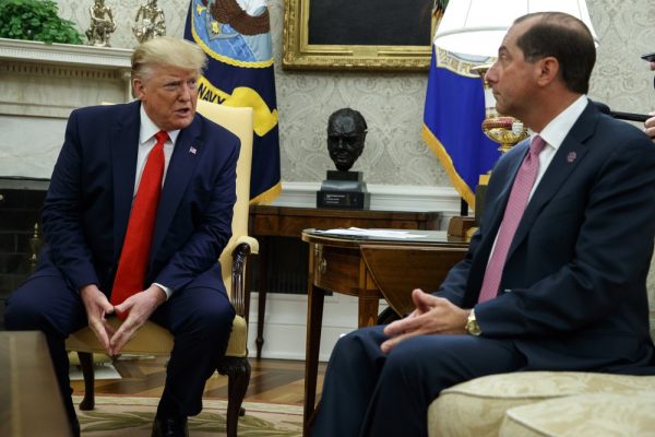President Donald Trump talks to Secretary of Health and Human Services Alex Azar about a plan to ban most flavored e-cigarettes,