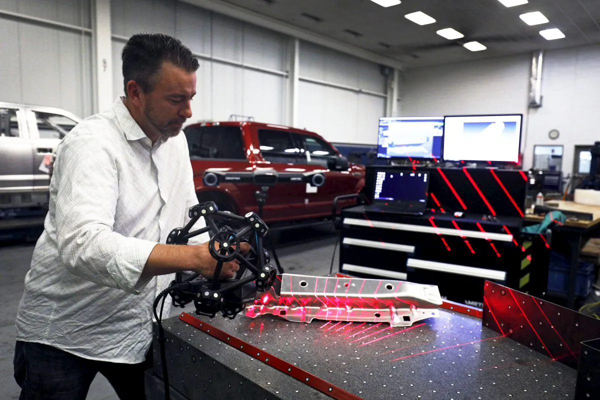 A Ford Motor Company worker operates a Creaform laser scanning measuring device at the Ford Dearborn Truck Plant in Dearborn, Mich., on Sept. 27, 2018. (Bill Pugliano/Getty Images)