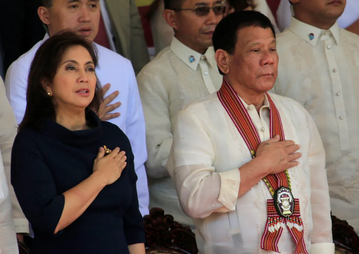 President Rodrigo Duterte and Vice-President Leni Robredo stand at attention for the national anthem during the Philippine National Police Academy (PNPA) graduation ceremony in Camp Castaneda, Silang town in Cavite city, Philippines on March 24, 2017. (Romeo Ranoco/Reuters)