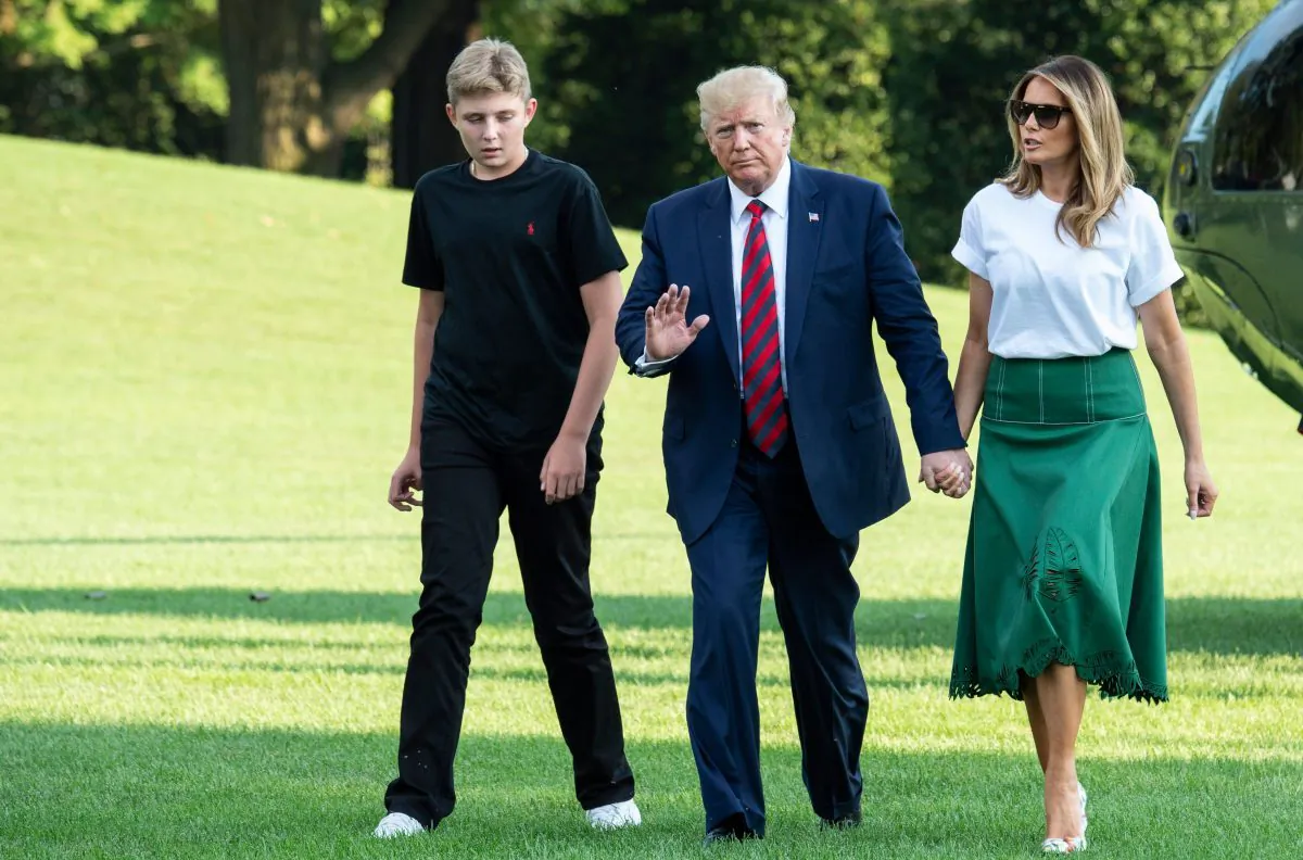 President Donald Trump (C), First Lady Melania Trump (R) and their son Barron Trump (L) return to the White House after two weeks spent at Trump's golf club in New Jersey on Aug. 18, 2019. (Eric Baradat/AFP/Getty Images)