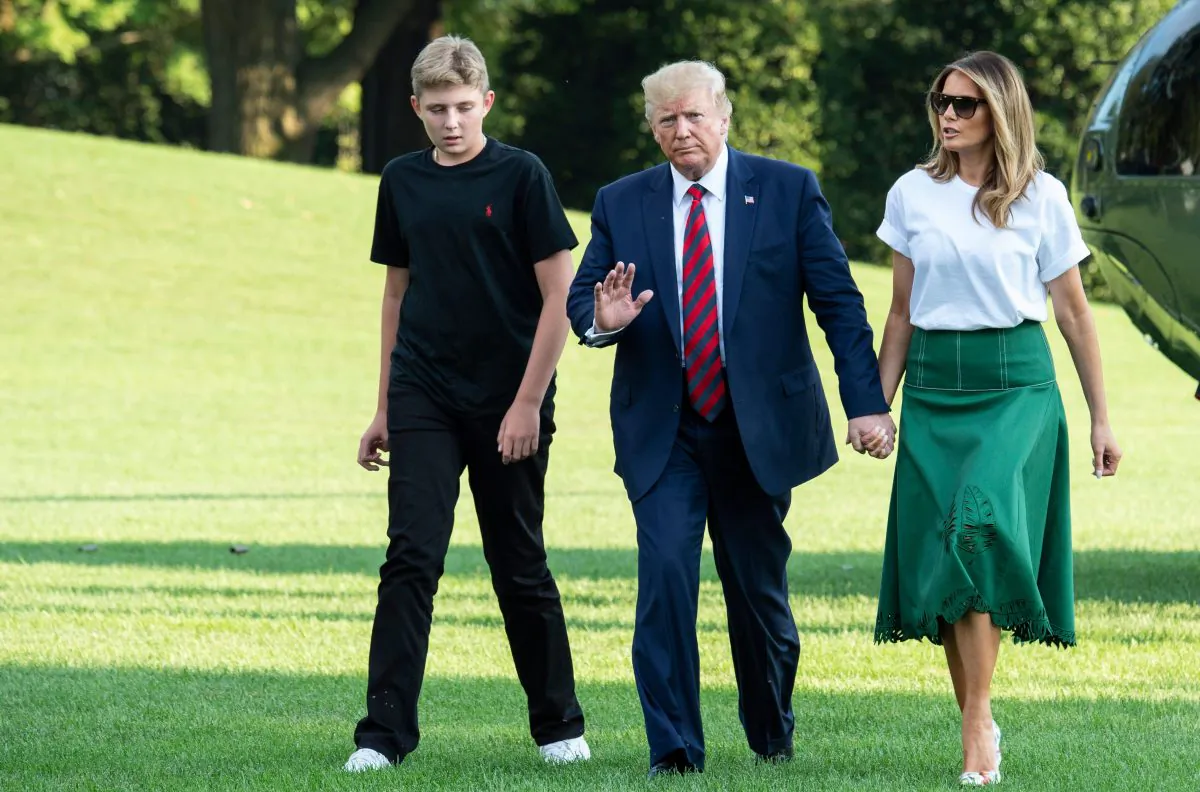 President Donald Trump (C), First Lady Melania Trump (R) and their son Barron Trump (L) return to the White House after two weeks spent at Trump's golf club in New Jersey on Aug. 18, 2019. (Eric Baradat/AFP/Getty Images)