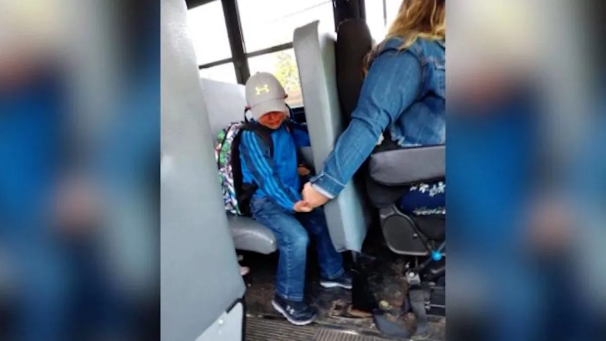 A four-year-old was nervous about the first day of school, so his bus driver held his hand for support. (Courtesy of Amy Johnson)