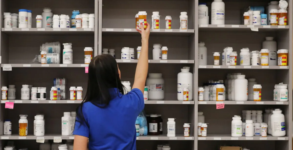 A pharmacy technician grabs a bottle of drugs off a shelf at the central pharmacy of Intermountain Heathcare, in Midvale, Utah, on Sept. 10, 2018.  (George Frey/Getty Images)