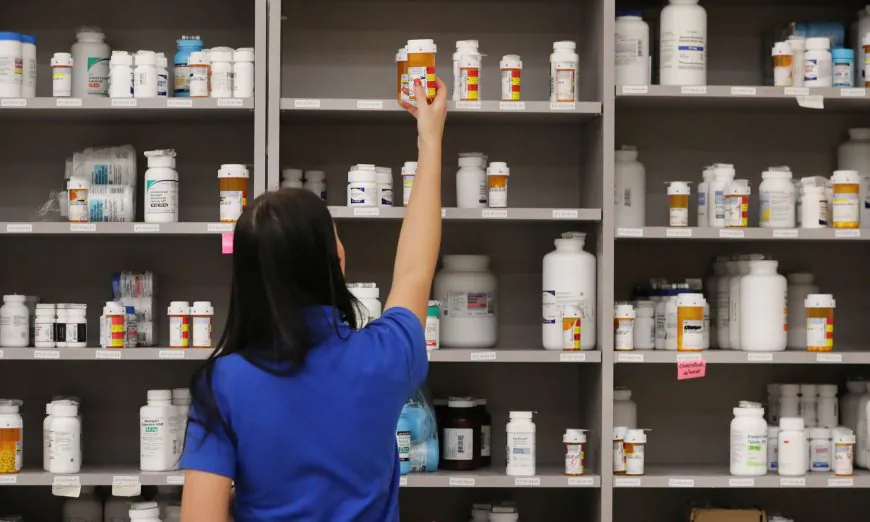 A pharmacy technician grabs a bottle of drugs off a shelve at the central pharmacy of Intermountain Heathcare on September 10, 2018 in Midvale, Utah.  (Photo by George Frey/Getty Images)