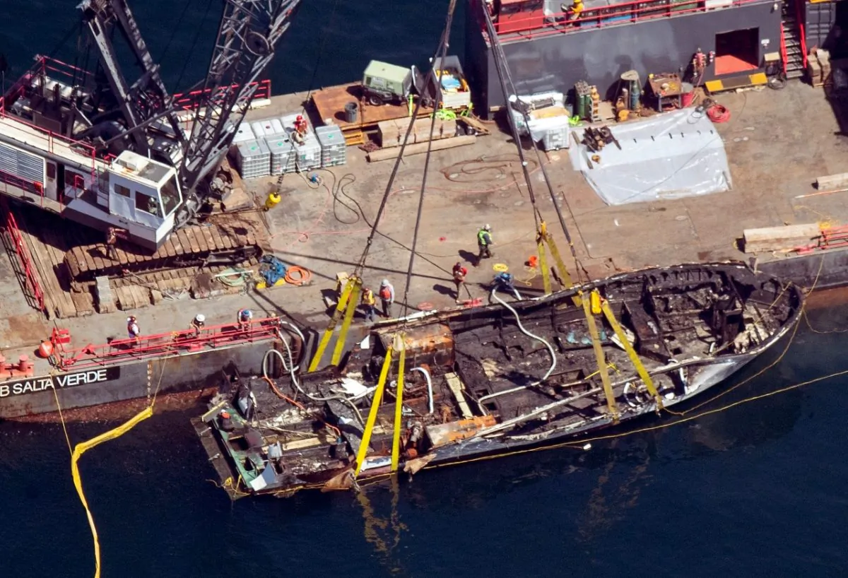 The burned hull of the Conception is brought to the surface by a salvage team off Santa Cruz Island in the Santa Barbara Channel in Southern California, on Sept. 12, 2019. (Brian van der Brug/Los Angeles Times via AP)