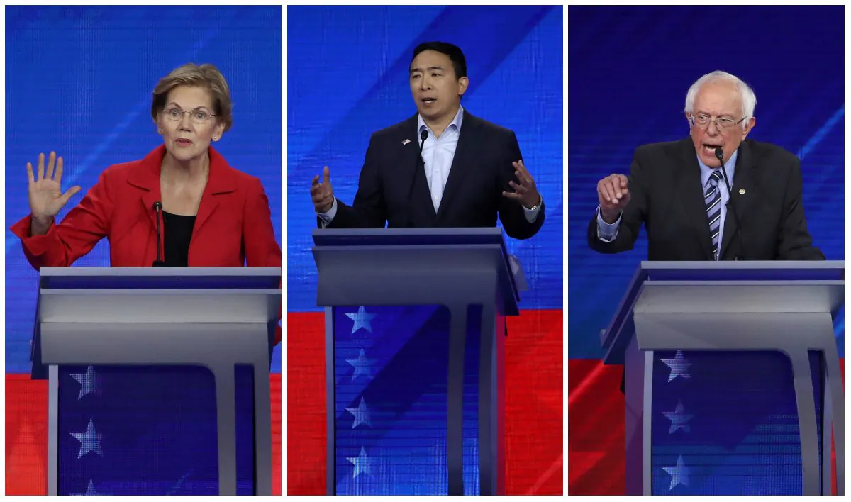 Sen. Elizabeth Warren (D-Mass.), left, entrepreneur Andrew Yang, center, and Sen. Bernie Sanders (I-Vt.), right, speak during the Democratic presidential debate in Houston, Texas on Sept. 12, 2019. (Win McNamee/Getty Images)