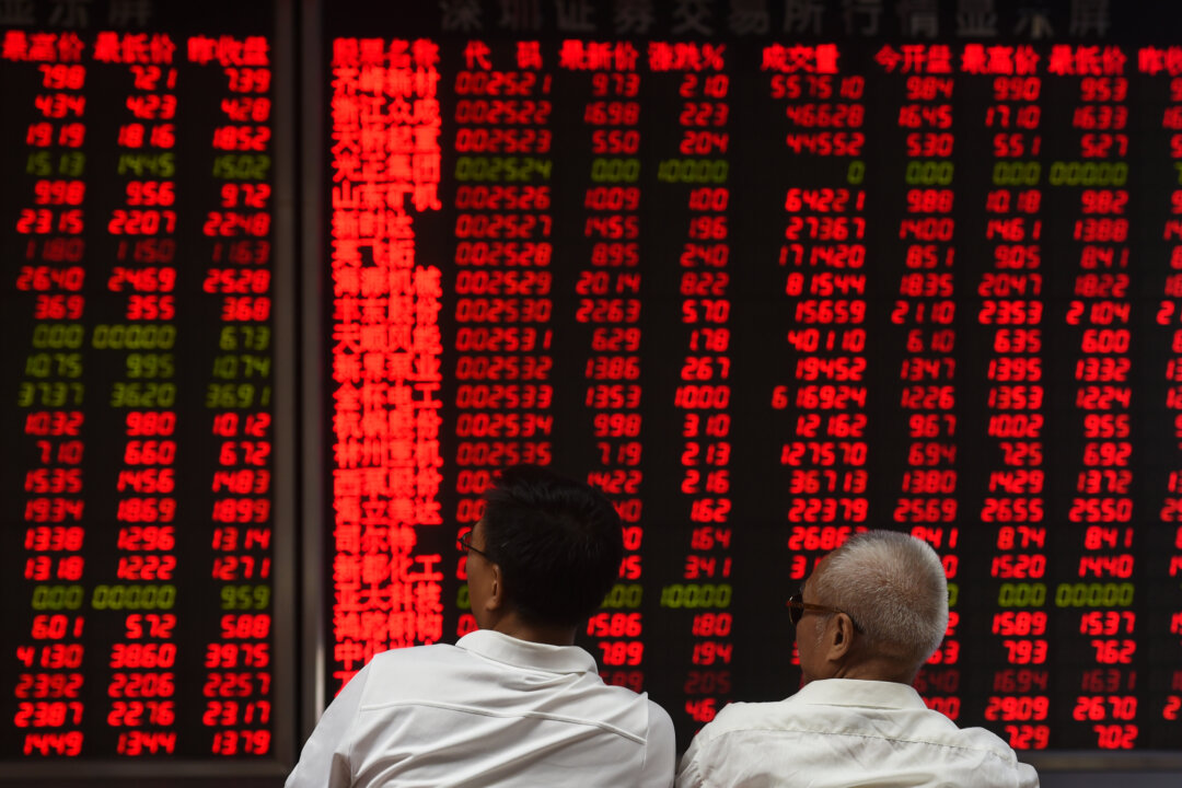 Investors monitor stock price movements at a securities company in Beijing on June 15, 2016.
(GREG BAKER/AFP/Getty Images)