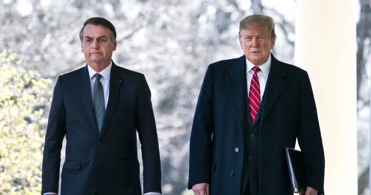 U.S. President Donald Trump (R) and Brazilian President Jair Bolsonaro (L) walk down the Colonnade before a press conference at the Rose Garden of the White House in Washington, DC on March 19, 2019.