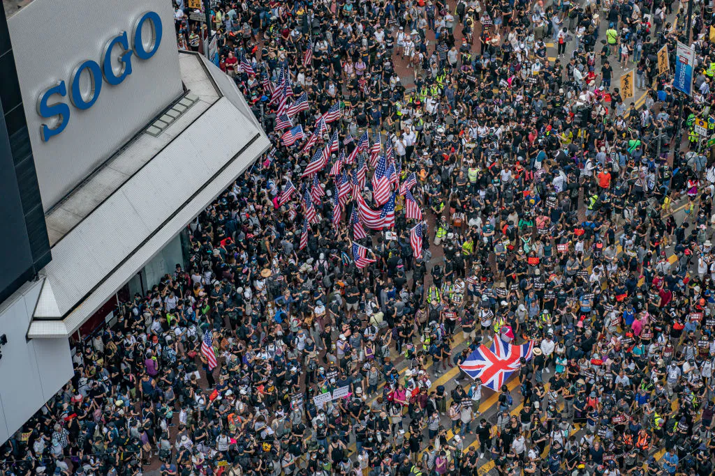 Protesters wave U.S flags as they gather ahead of a pro-democracy march in Hong Kong on Sept. 15, 2019. (Anthony Kwan/Getty Images)