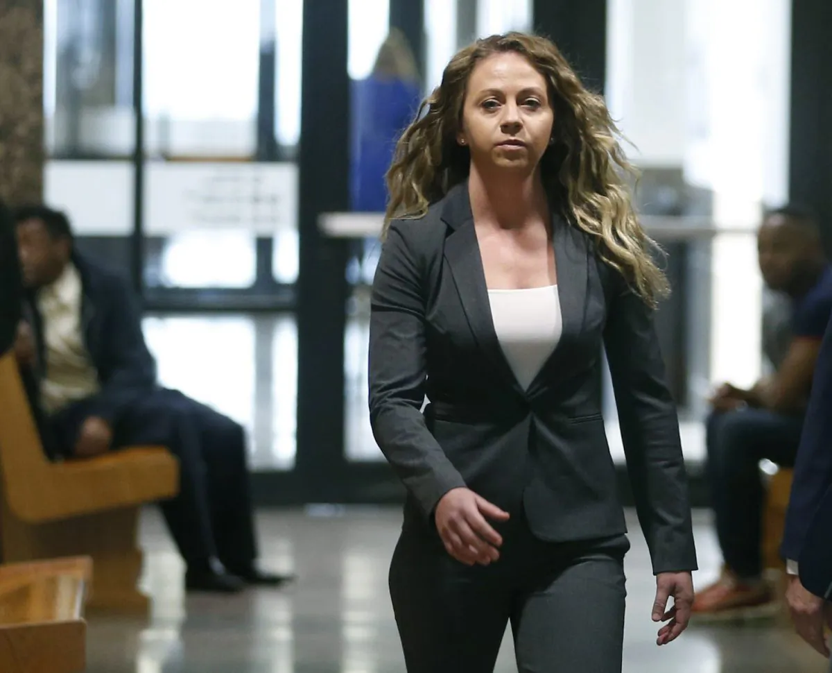 Former Dallas Police officer Amber Guyger walks the hallway on her third court appearance at the Frank Crowley Courts Building in Dallas, on March 18, 2019. (Vernon Bryant/The Dallas Morning News via AP, File)