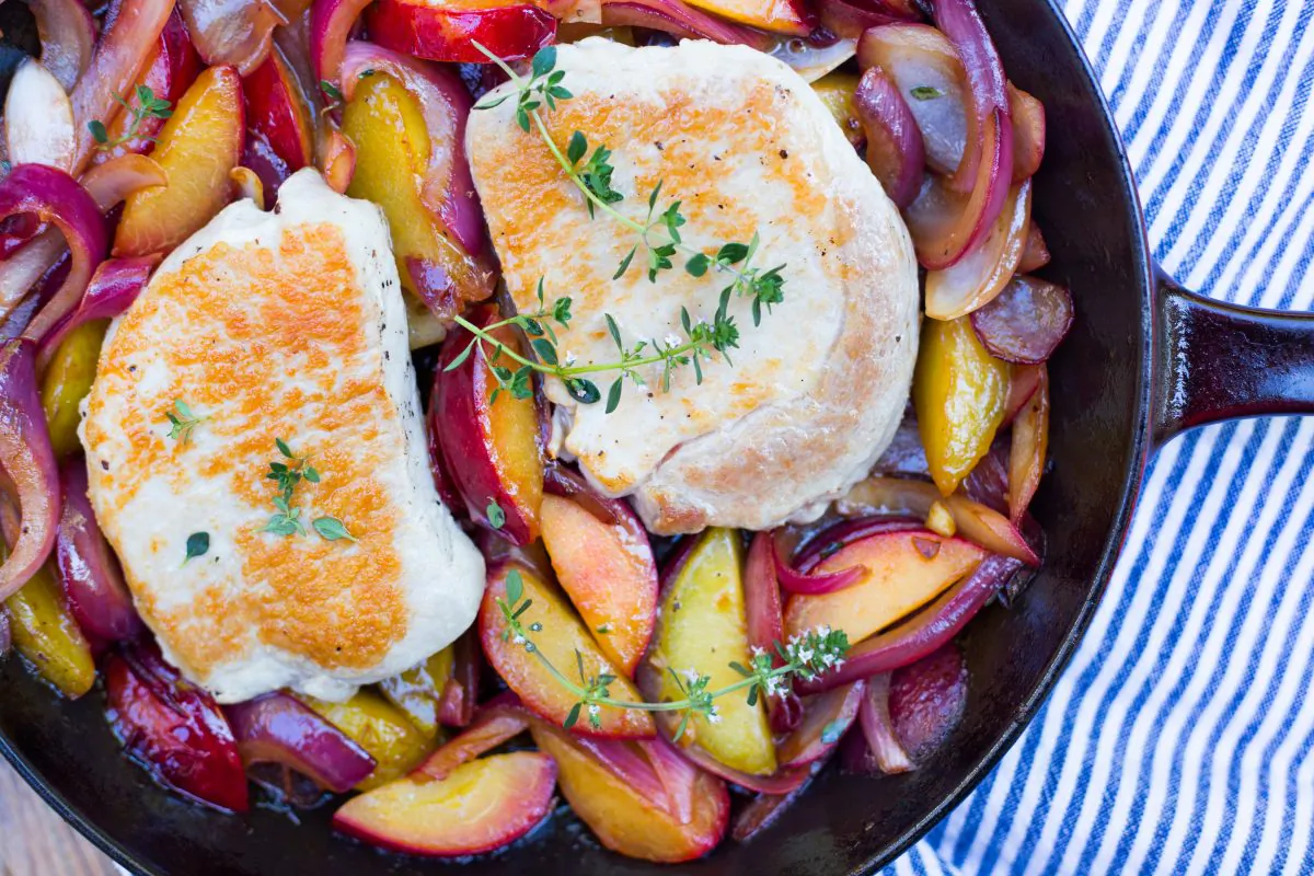 One-skillet pork chops with cooked plums. (Caroline Chambers)