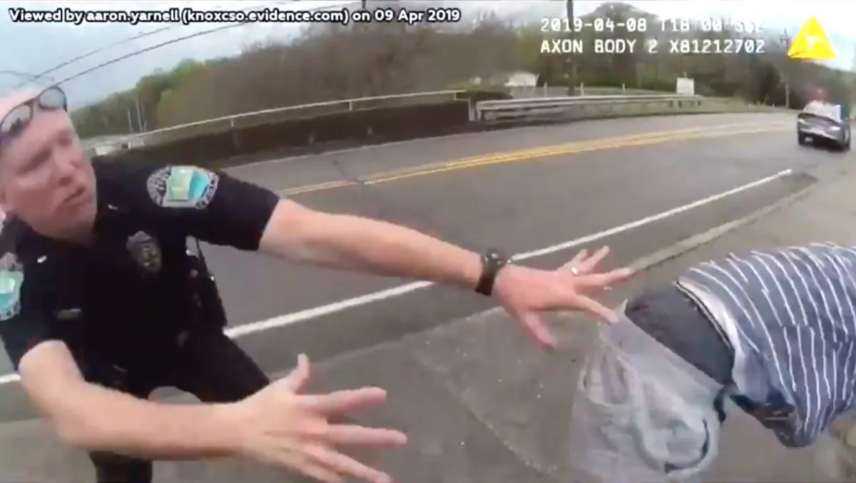 Knox County Sheriff's Office traffic unit officer Brian Rehg lunges towards a would-be jumper at a bridge on Pleasant Ridge Road, on April 8, 2019.
(Knox County Sheriff's Office)
