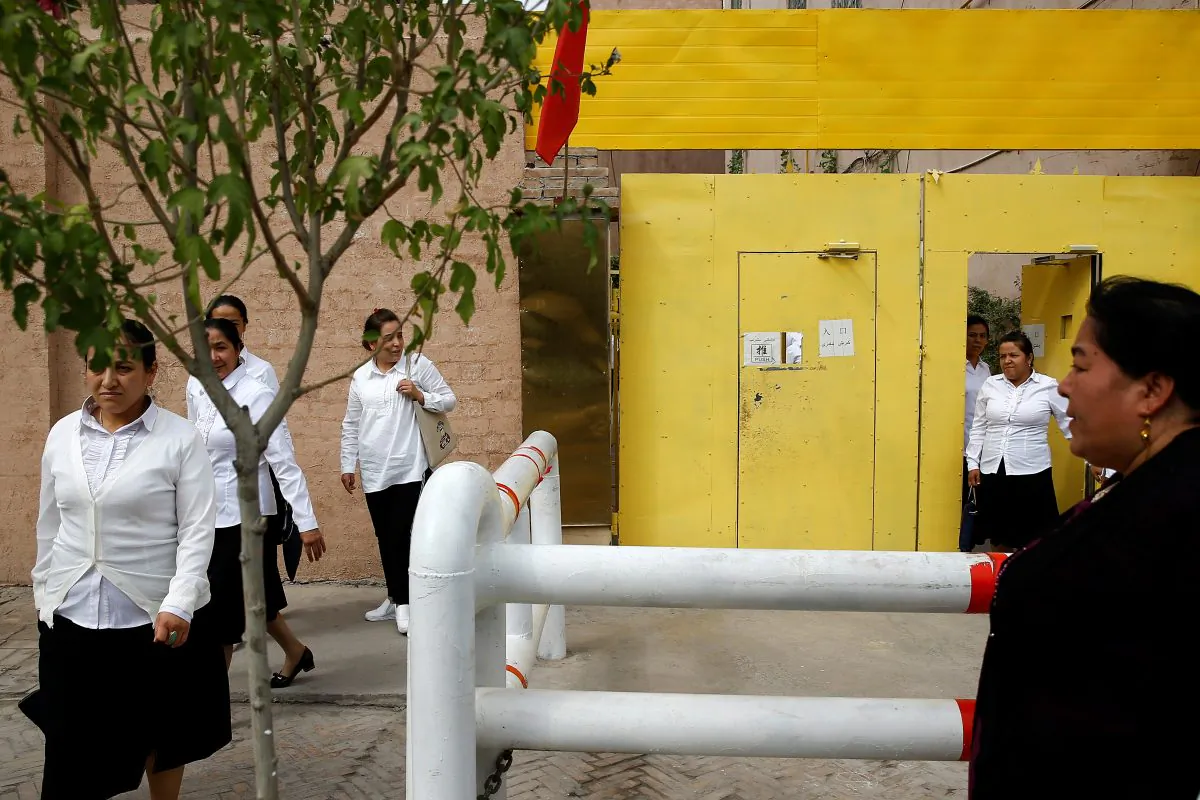 Ethnic Uyghur women leave a center where political education lessons are held in Kashgar, in Xinjiang Uyghur Autonomous Region, China on Sept. 6, 2018. (Thomas Peter/Reuters)